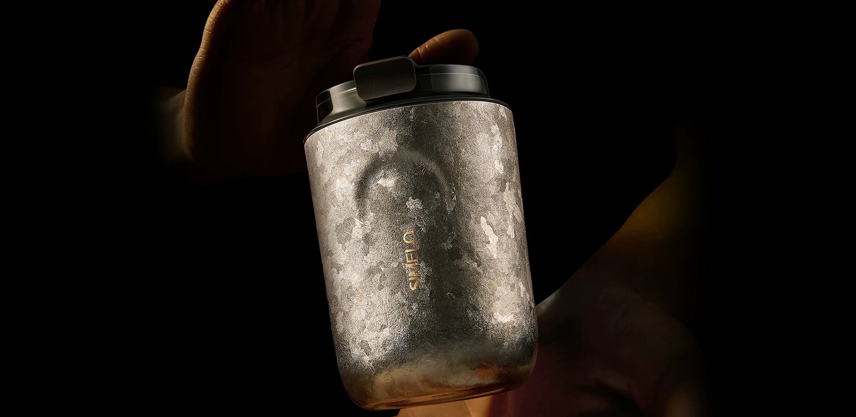 Titanium tumbler held in hand